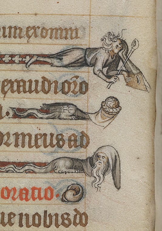 Close-up of grotesques drawn in the margins of a medieval manuscript.