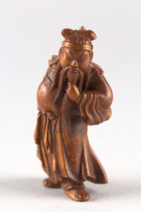 Netsuke man holding beard