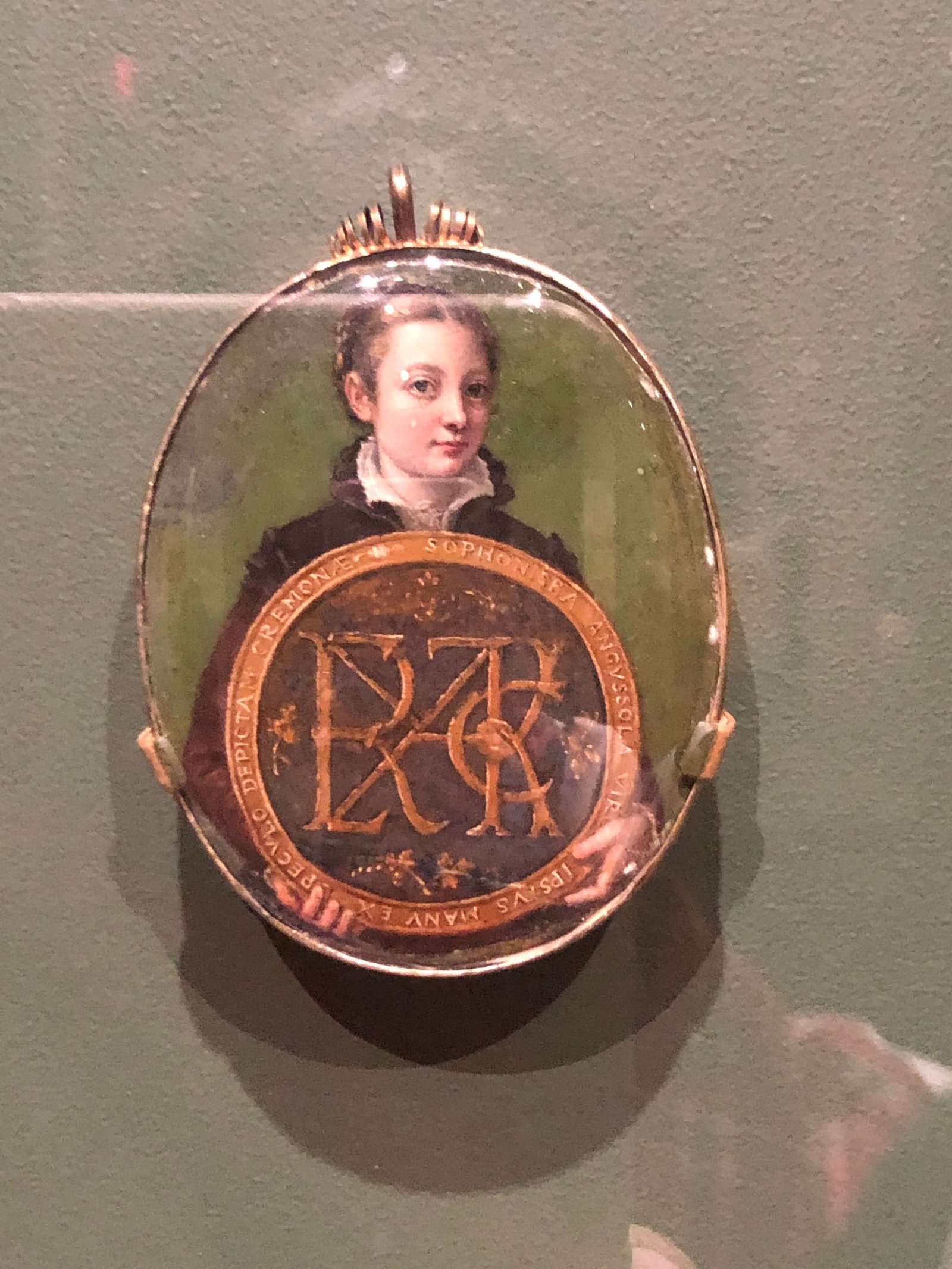 Female self portrait holding a medallion