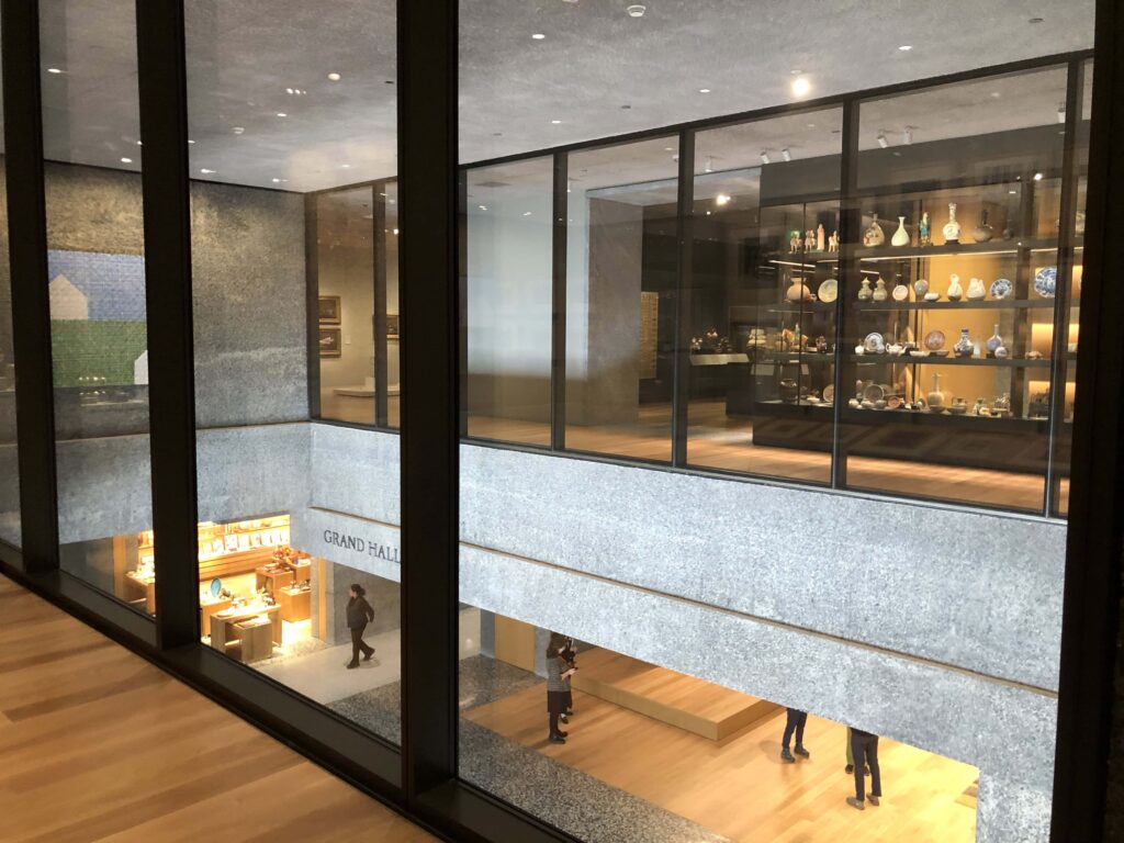 Glass cases with porcelain and a building lobby below