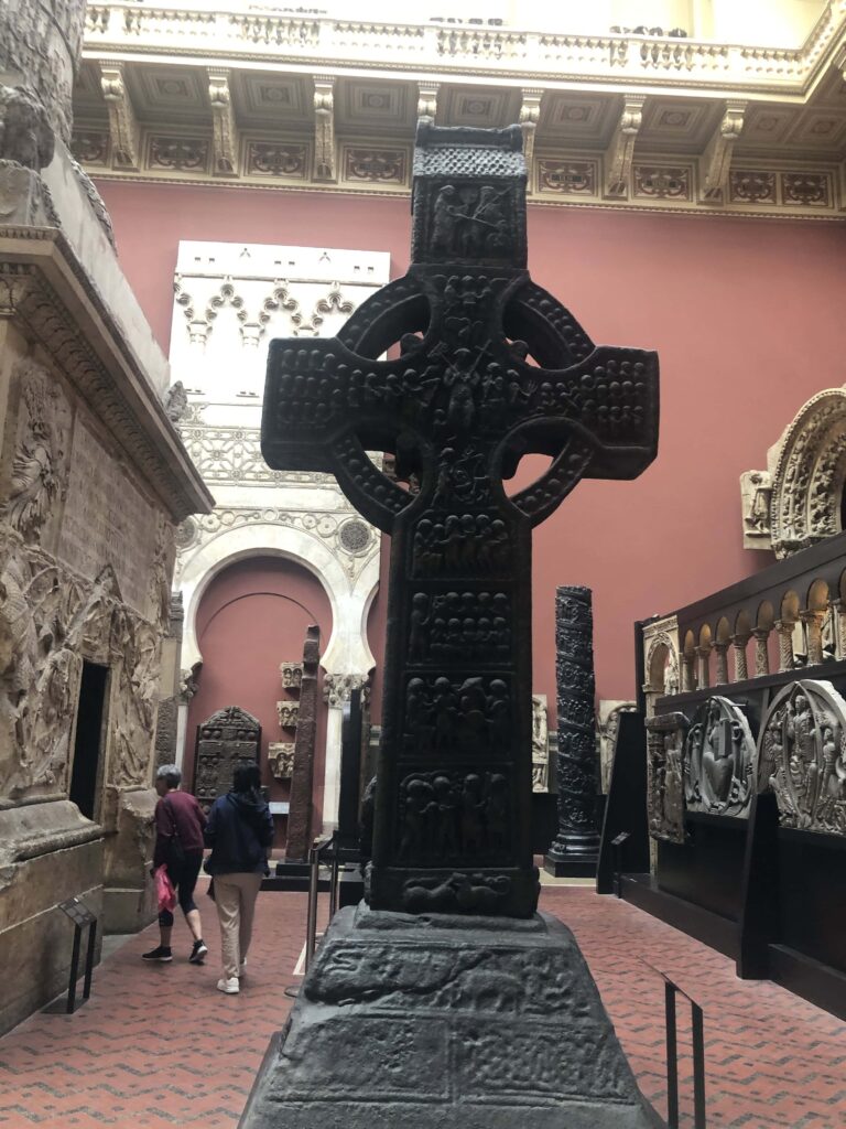 A large Celtic cross and other large-scale artworks in a large gallery