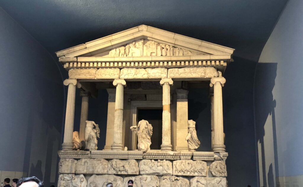 A classical tomb with statues.