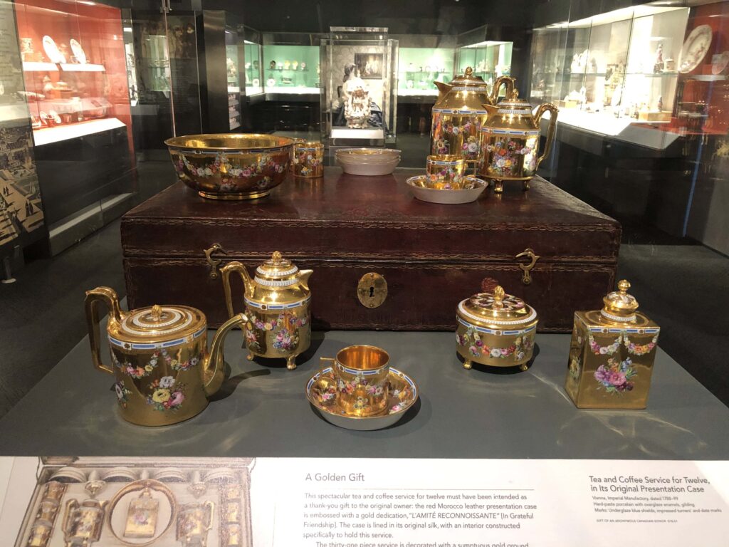 A golden coffee service in a museum gallery