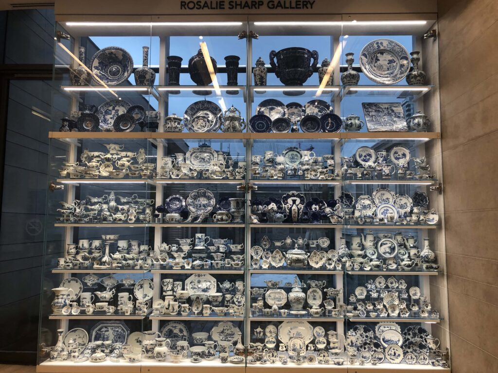 A floor-to-ceiling glass case filled with porcelain